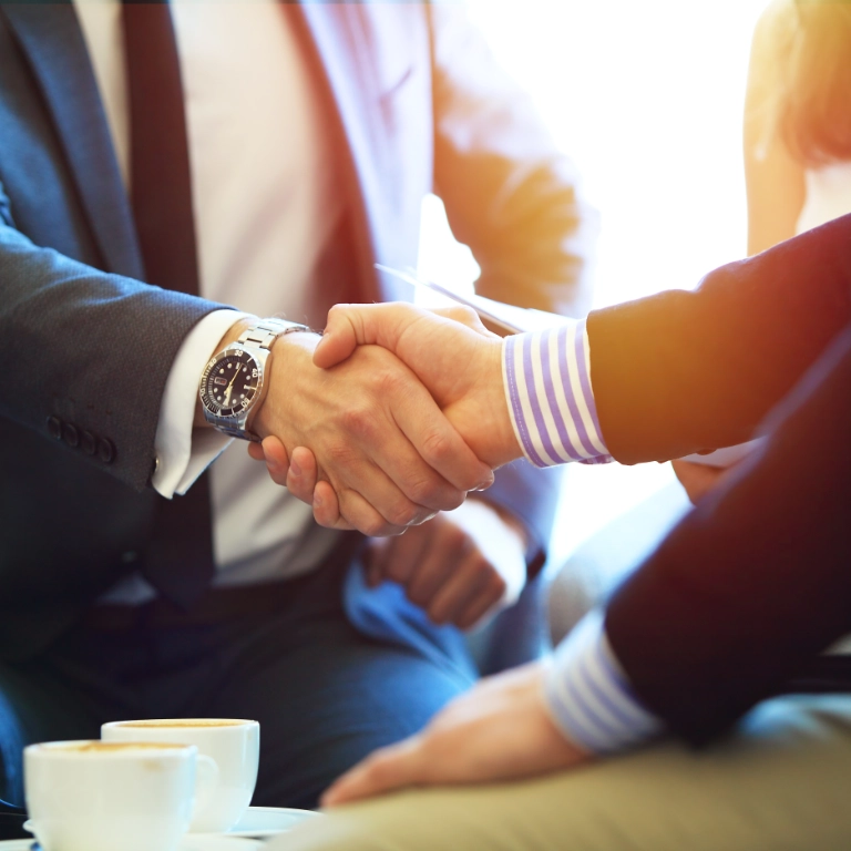 business people shaking hands finishing up a meeting