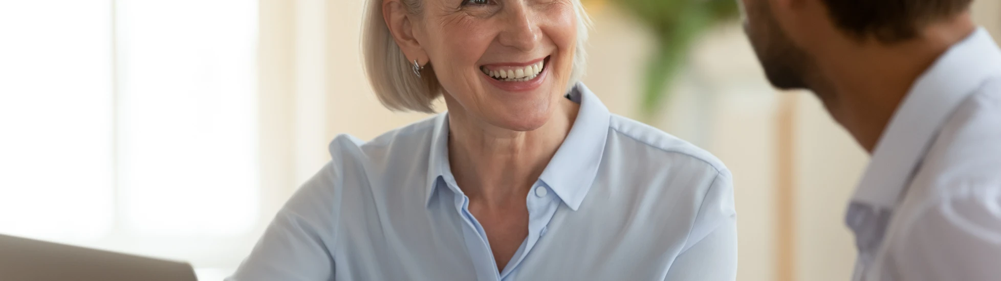 Middle aged woman talking to a male colleague