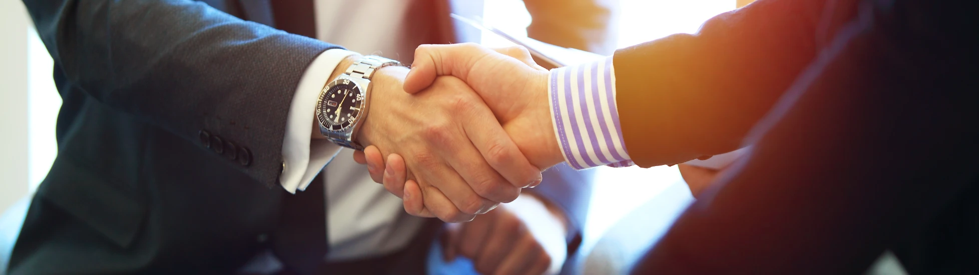 business people shaking hands finishing up a meeting