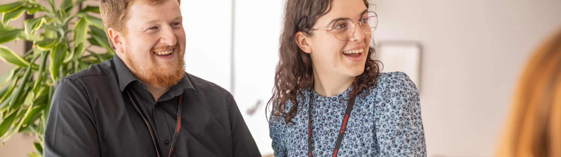 Two Atradius colleagues sharing a comment in a breakout area