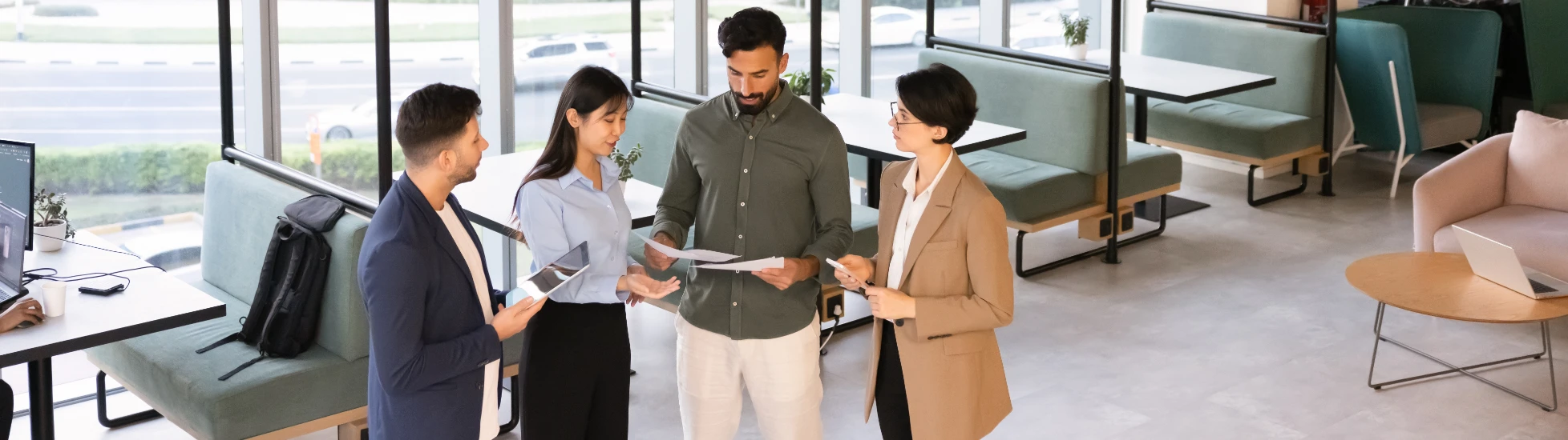 2749827291 - Horizontal view group of businesspeople collaborate on paperwork and digital tablet in coworking office,