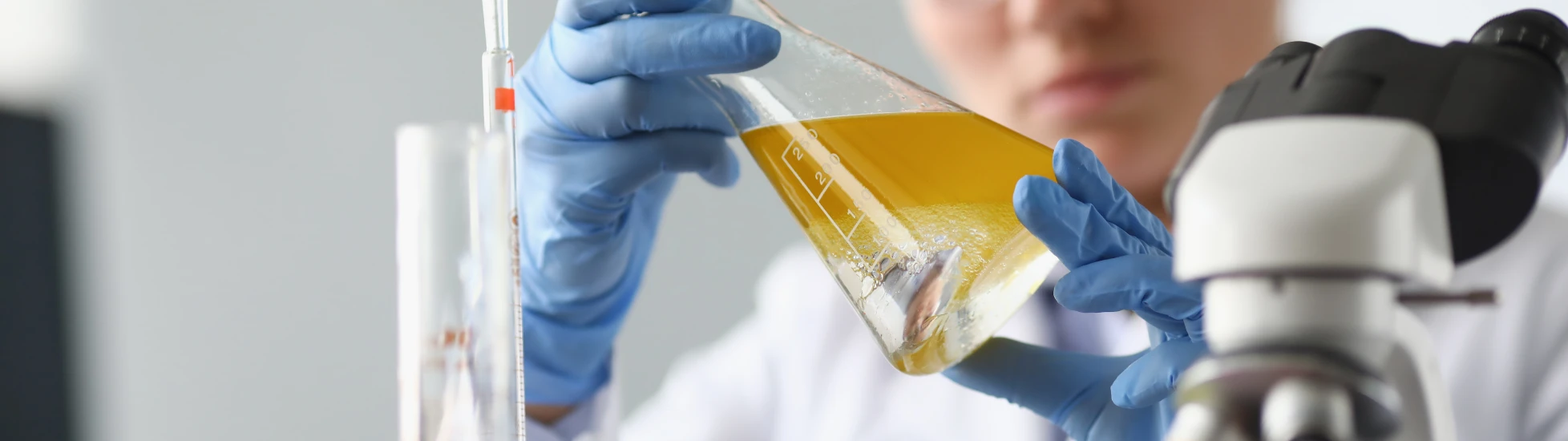 woman chemist scientist holding flask at hand