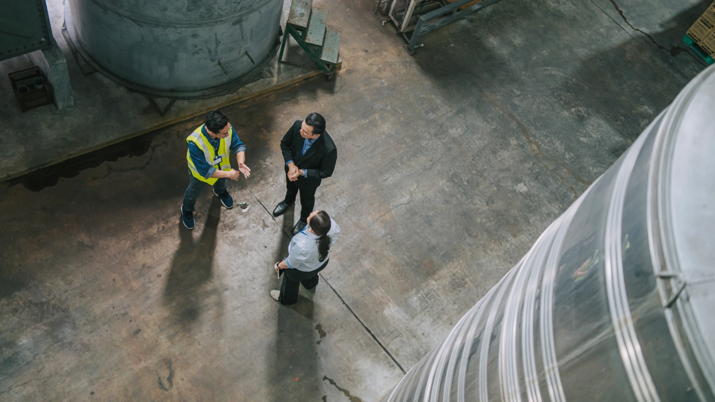 Workers having a discussion in a large warehouse