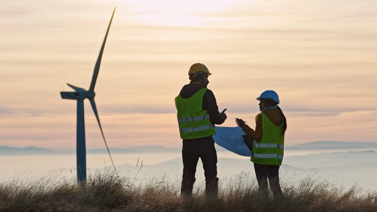 Two wind turbine engineers at sunset (FLIPPED) image