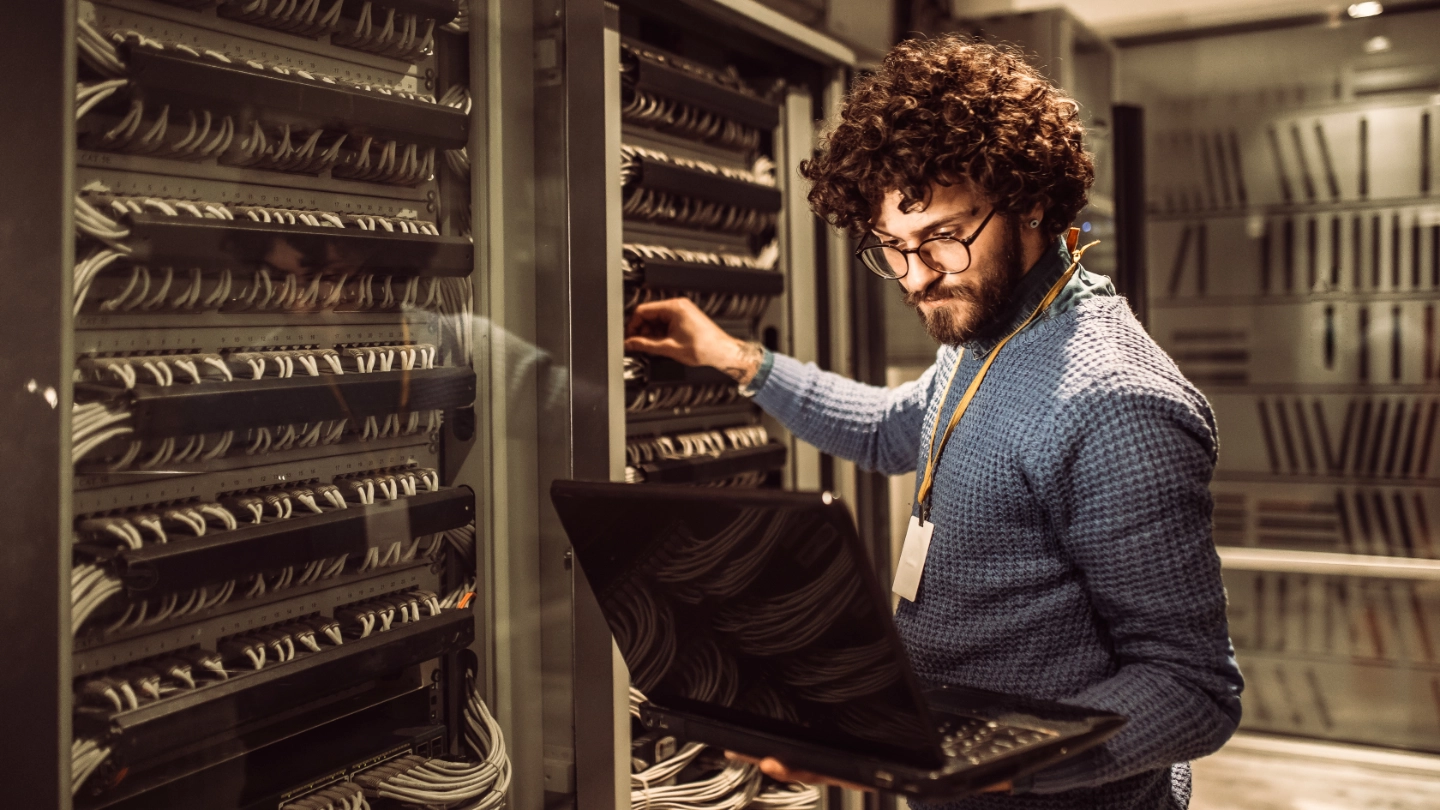 bearded male worker in mainframe room image