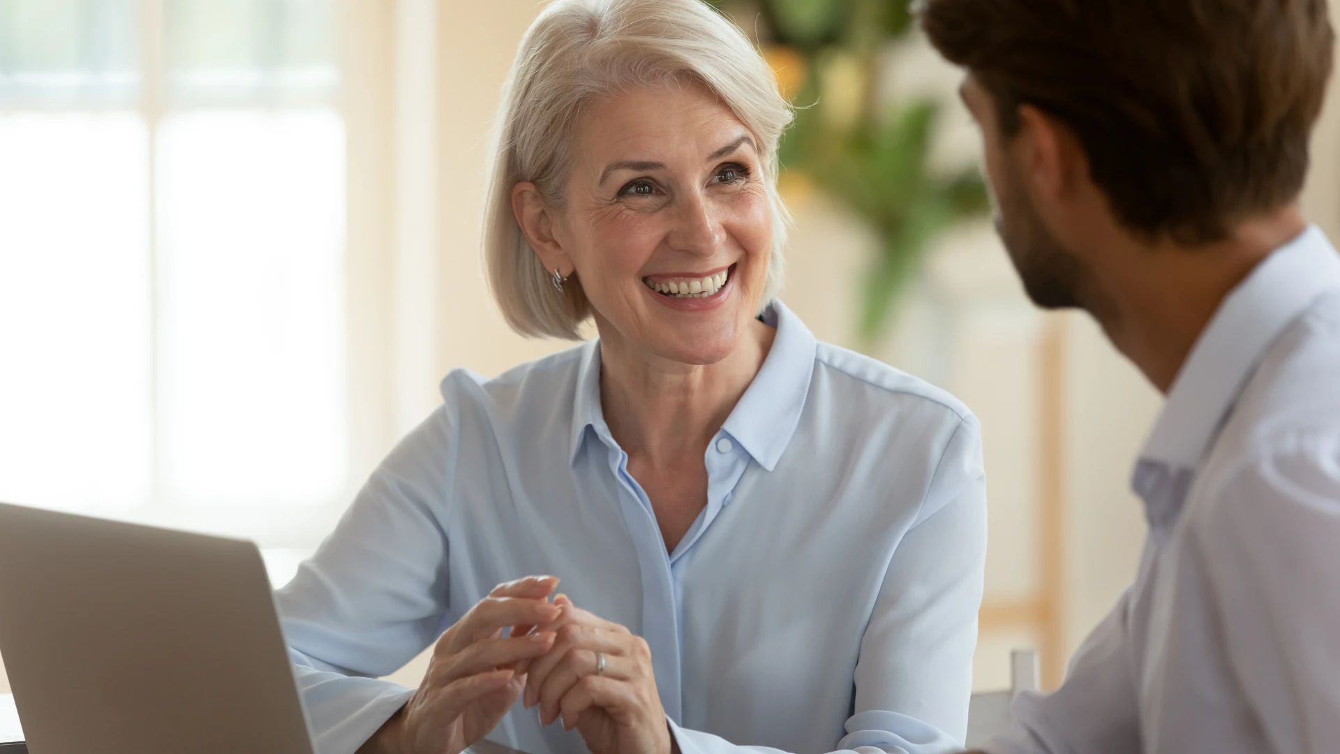 Middle aged woman talking to a male colleague
