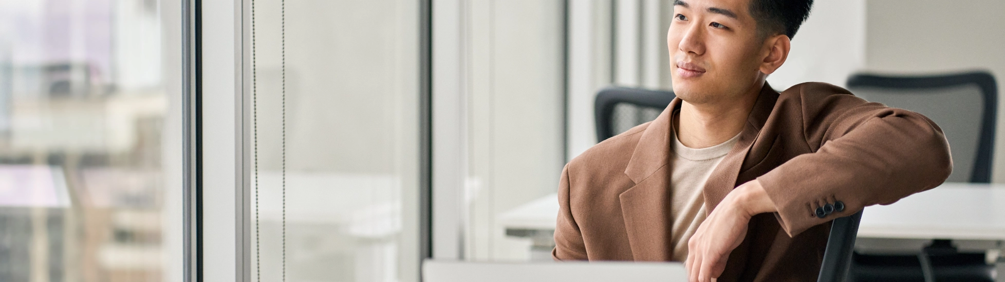 man behind desk with laptop