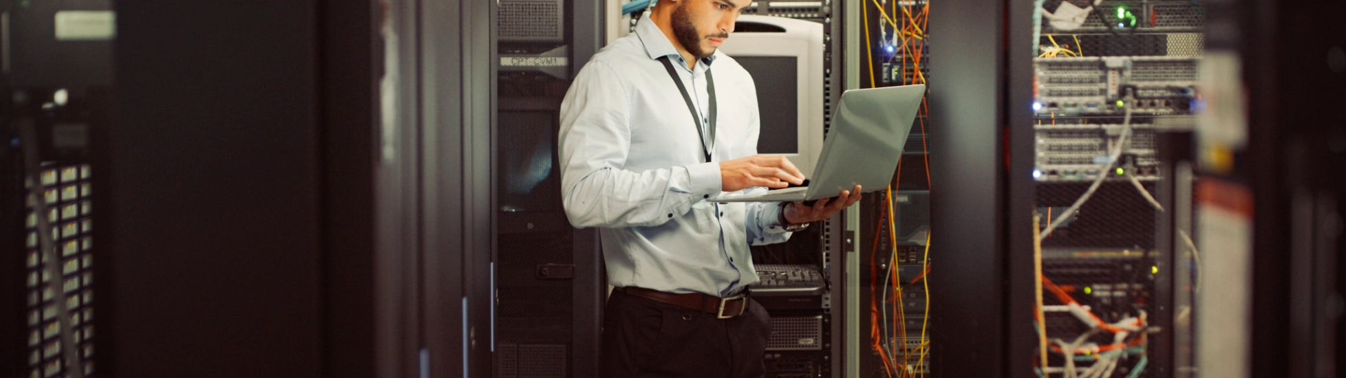 Young male worker in computer room