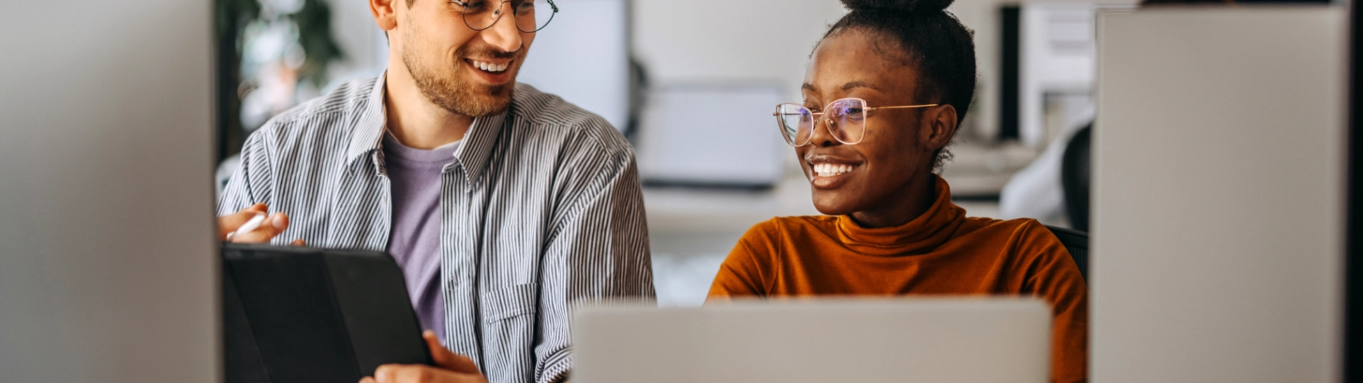 woman and man behind computers
