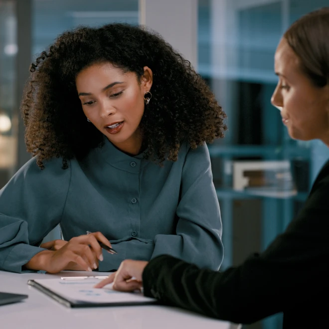 Two female colleagues reviewing some information  