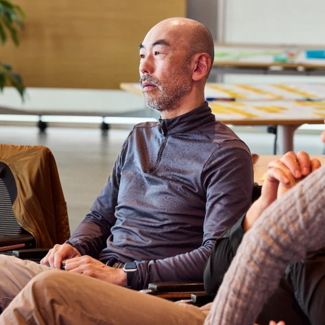 Asian Atradius colleague watching a presentation