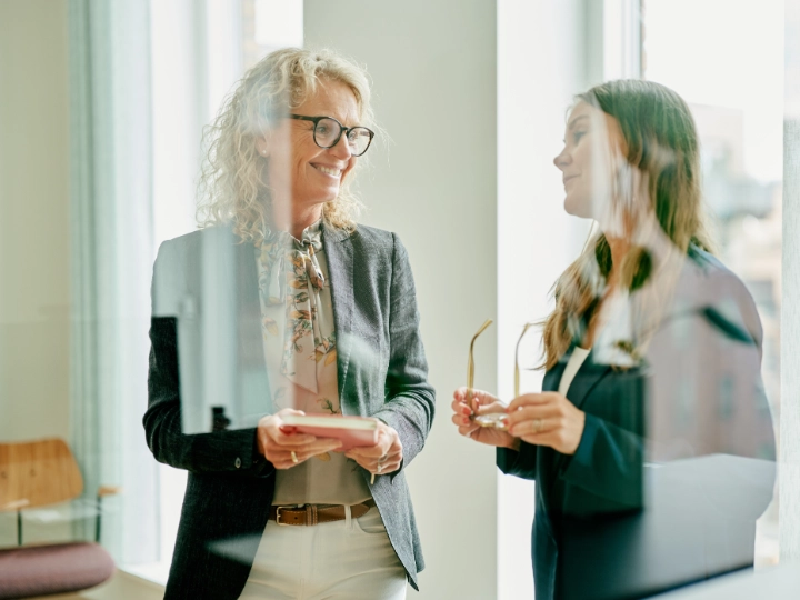 Atradius Danish colleagues talking in the office