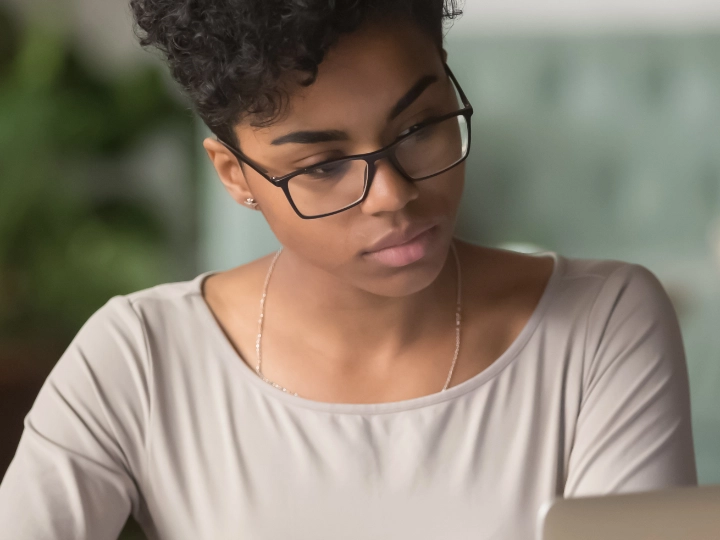 Woman studying data on a laptop