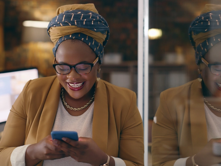 Ethinic woman in a head dress using a mobile phone